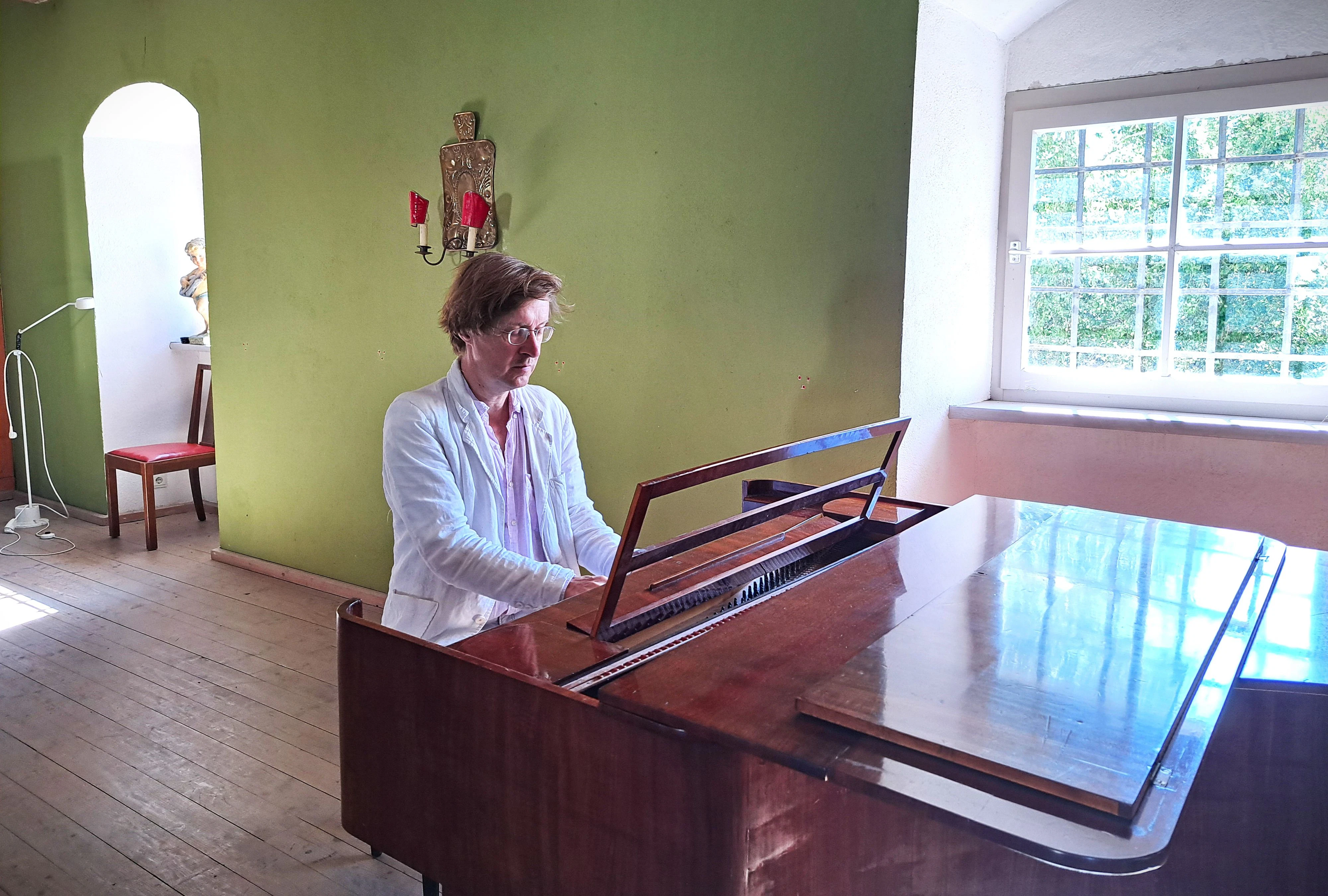 Ein Klavier in beinahe jedem Raum: Jan Kobow im Konzertsaal seines Schlosses.
